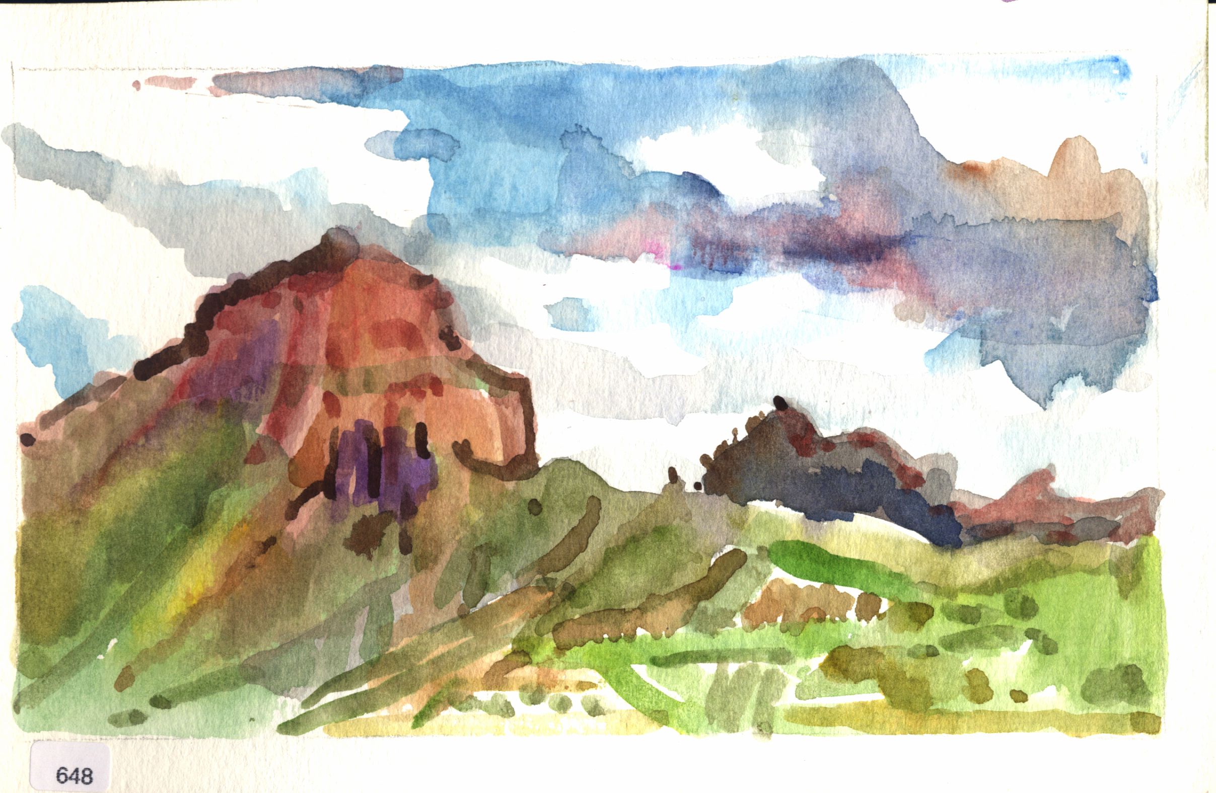 Red and green hills under a cloudy sky.