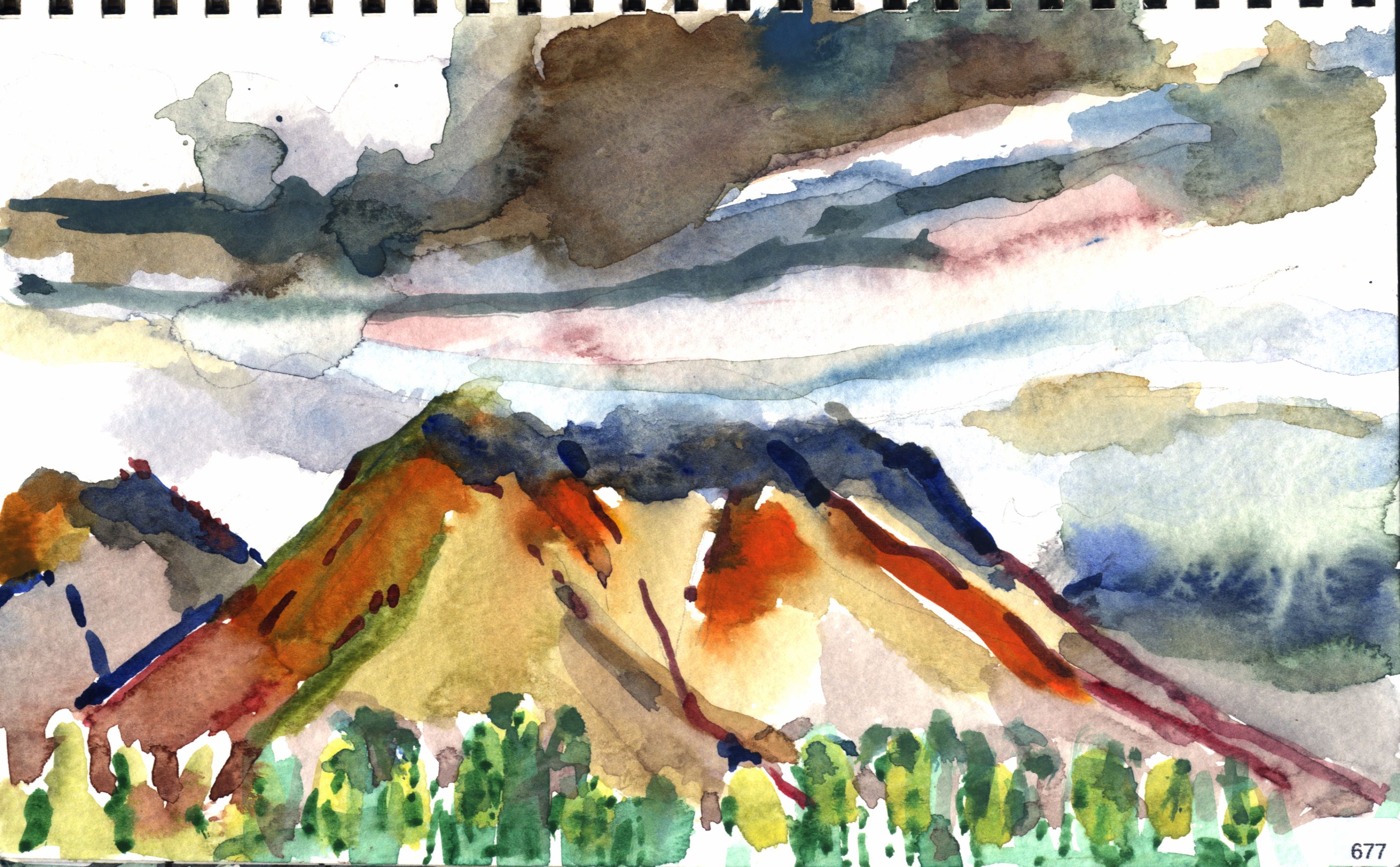 Maui, Warm-toned hills or mountains under a stormy sky with green foreground trees.