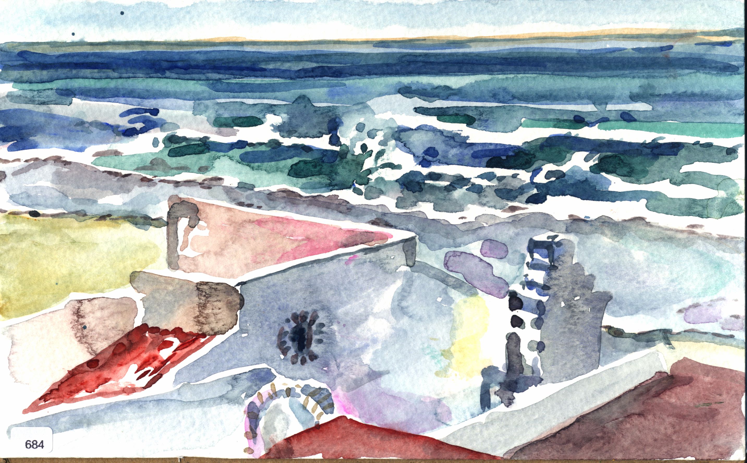 View over rooftops toward ocean waves and surf.