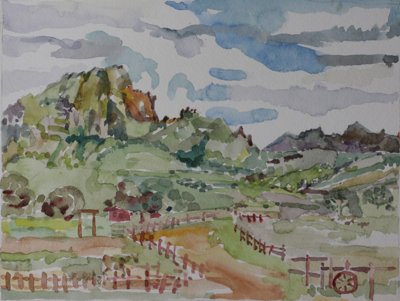 Green mountains and valley and wooden post fence