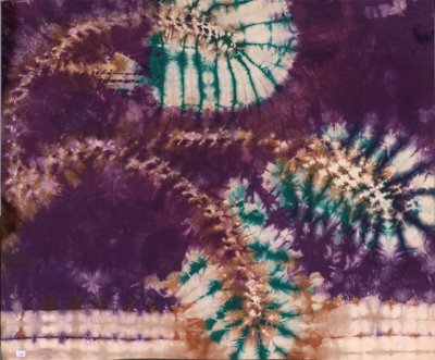 Green frond-like branches against purple background